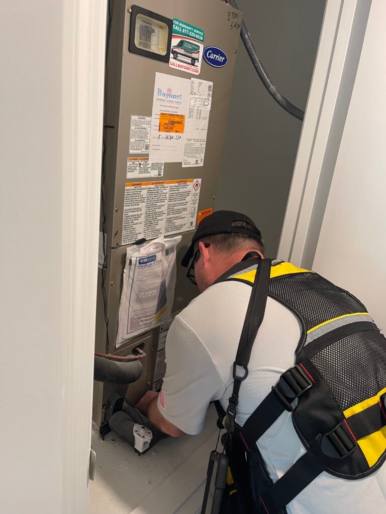 Rob inspecting a heating and air unit during a hoe inspection
