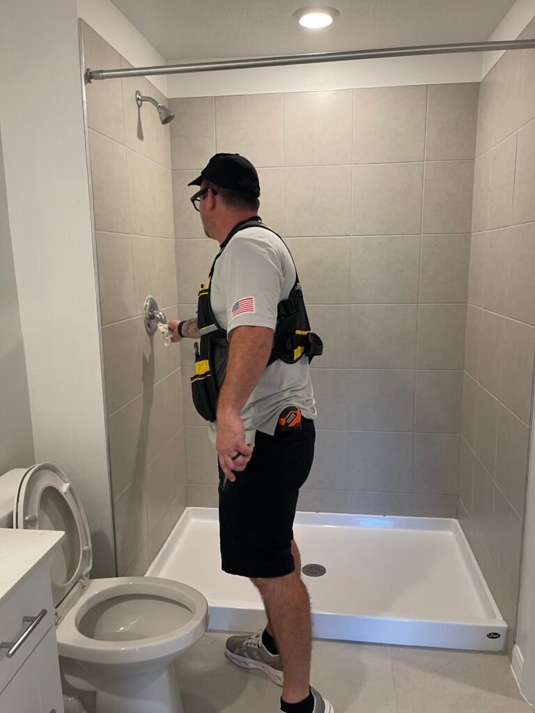 Rob inspecting the shower in the bathroom during an inspection