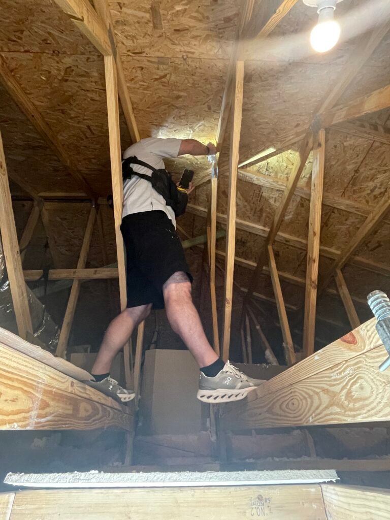 Rob inspecting the attic during a home inspection